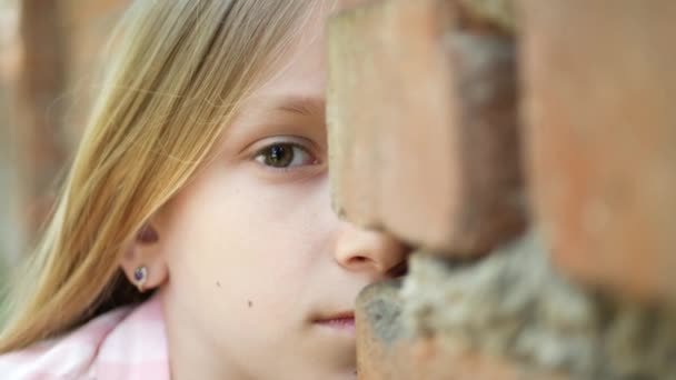 Barnelek gjemsel, redd ungeportrett, ansiktsjente bak vegger, spionerende barn utendørs i Park, smilende øyne Uttrykk – stockvideo