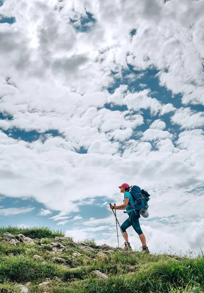 Vertikales Bild Einer Backpackerin Die Mit Trekkingstöcken Und Hellem Wolkenhintergrund — Stockfoto