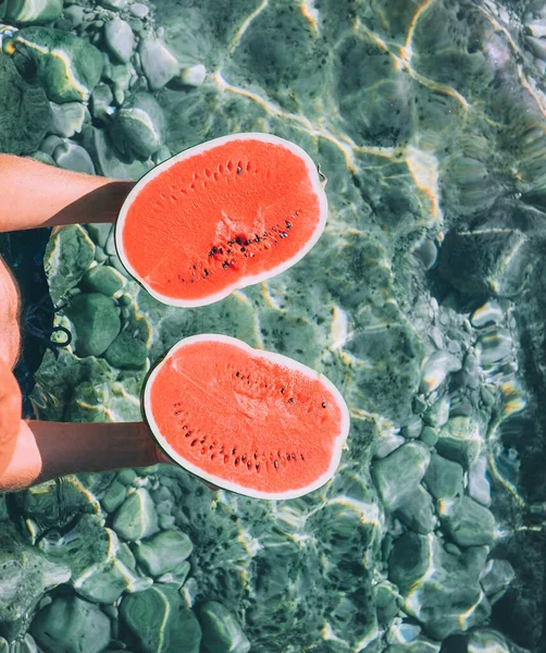 Man Holds Hands Two Melon Halfs Stands Crystal Clear Sea — Stock Photo, Image