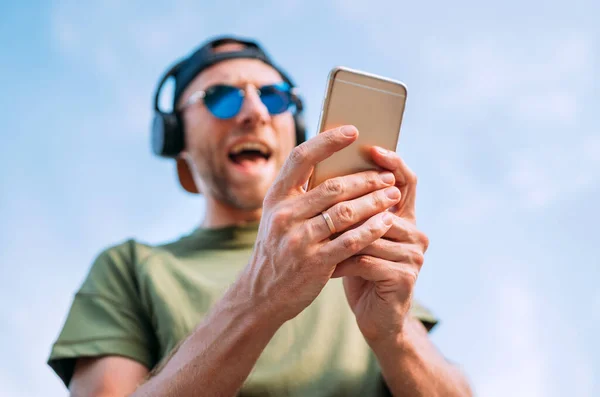 Cool Man Baseball Cap Wireless Headphones Blue Sunglasses Browsing His — Stock Photo, Image