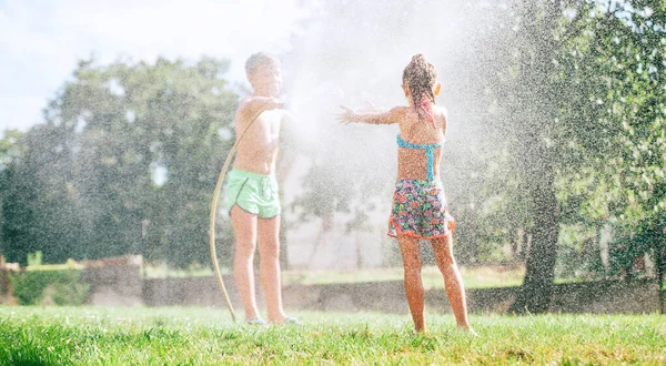 Dos Niños Hermano Hermana Juegan Con Manguera Riego Jardín Verano —  Fotos de Stock