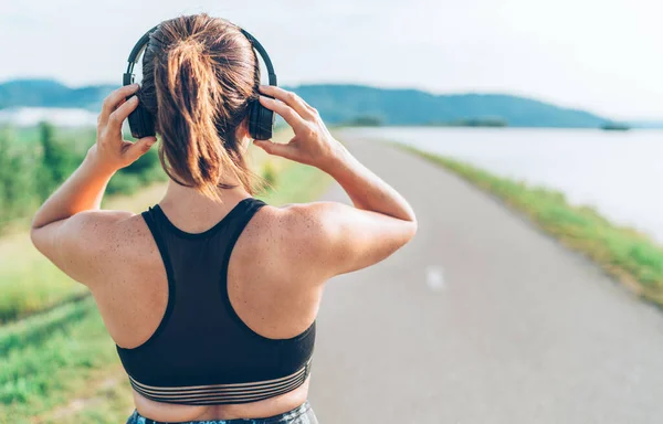 Young Teenager Girl Adjusting Wireless Headphones Starting Jogging Listening Music — Stock Photo, Image