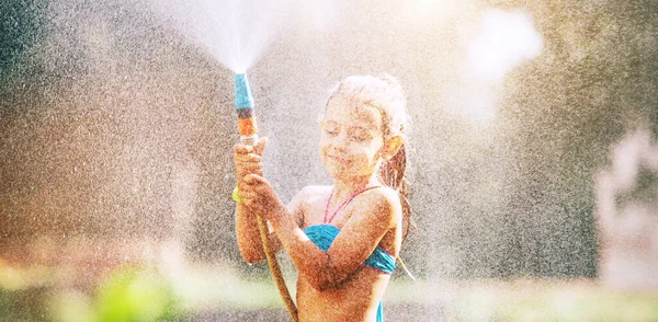 Cute Little Girl Sprinkls Water Herself Hose Makes Rain Pleasure — Stock Photo, Image