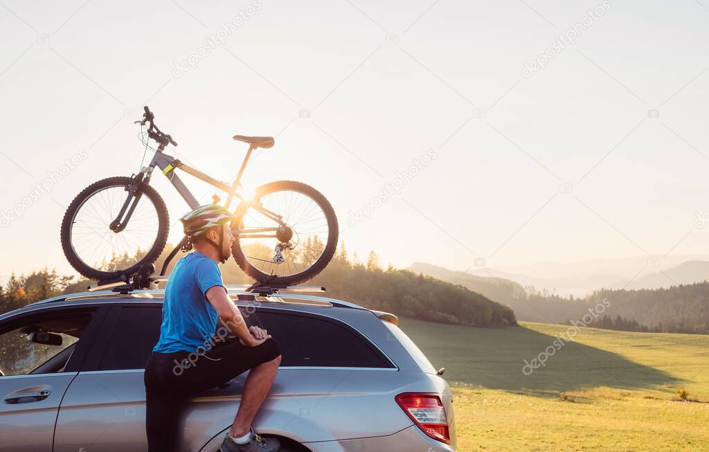 Man came by auto in mountain with his bicycle on the roof. Mountain biking concept