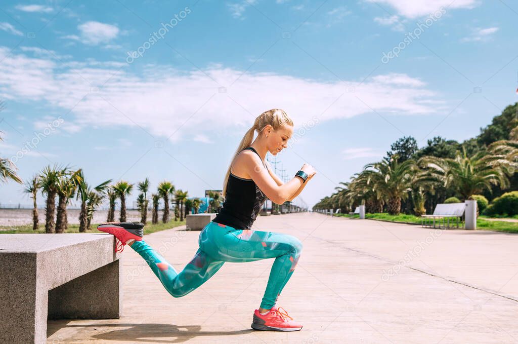 Young woman has an outdoor workout on the sea embankment