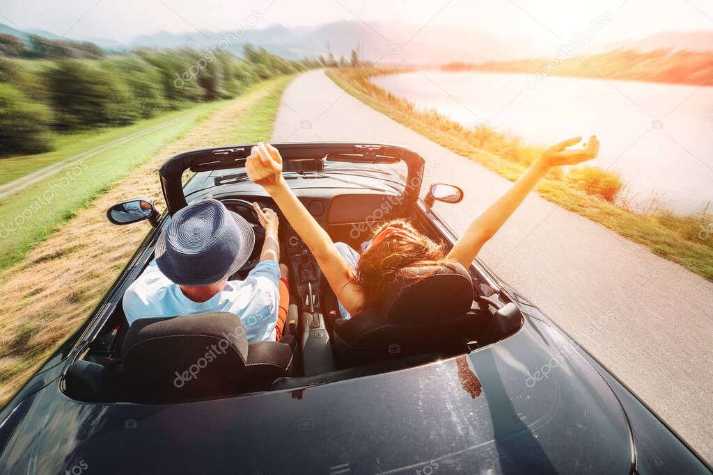 Couple in love ride in cabriolet car