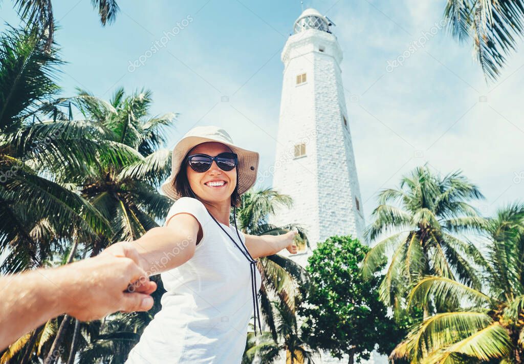 Dondra lighthouse in Sri Lanka: woman traveler take for hand her boyfreind and goes to lighthouse