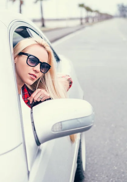 Ładna Młoda Blondynka Wygląda Przez Okno Samochodu — Zdjęcie stockowe