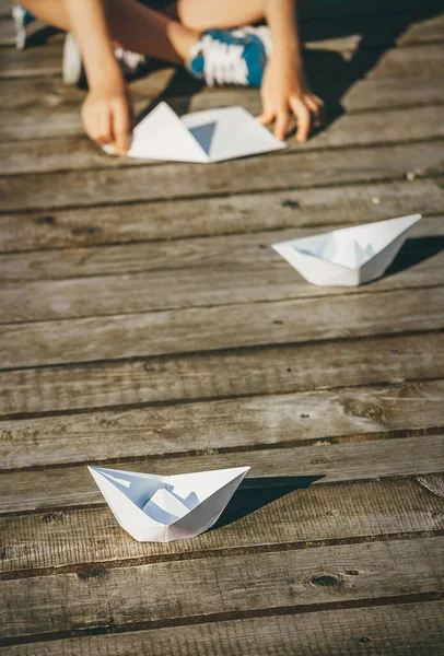 Child Makes Paper Boats Sitting Wooden Pier — Stock Photo, Image