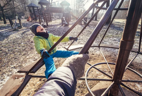 子供の遊び場の深い秋 男の子はカルーセルをオンにします — ストック写真