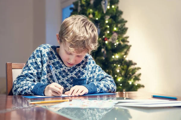 Little Boy Write Congratulations Christmas Card — Stock Photo, Image