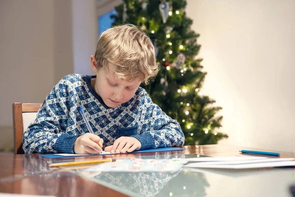 Boy Write Congratulations Christmas Card Cozy Home — Stock Photo, Image