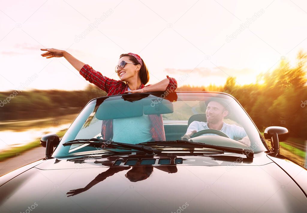 Couple in love traveling by cabriolet