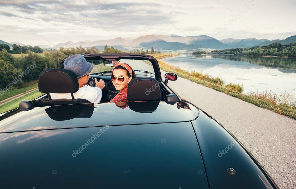 In love couple traveling by cabriolet car