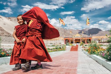 Ladakh, Hindistan 'daki Thiksey köyü - 20 Ağustos 2016' da Hindistan 'ın Ladakh kentindeki Thiksey Manastırı' nda yürüyen ve gülümseyen iki küçük çocuk rahip.