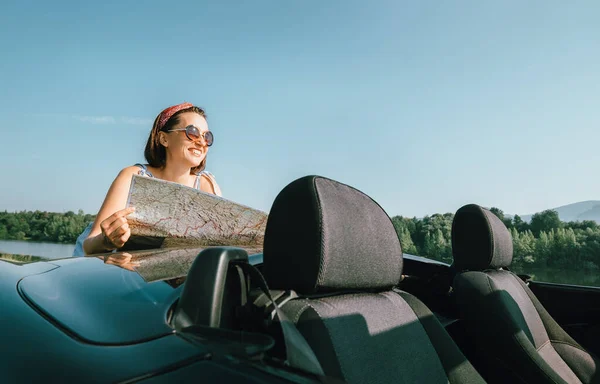 Kadın Otomobil Yolculuğu Sırasında Bir Yol Haritası Okuyor — Stok fotoğraf