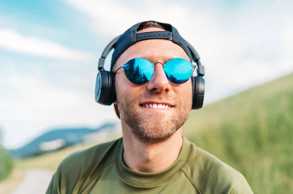 Cool Man Baseball Cap Wireless Headphones Blue Sunglasses Smiling Enjoying — Stock Photo, Image