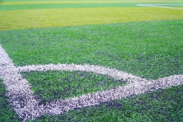 Front view of green soccer field.Beautiful artificial grass on the stadium.Abstract football turf ground background with white stripe line and corner kick.Background,Sport,Texture Concept