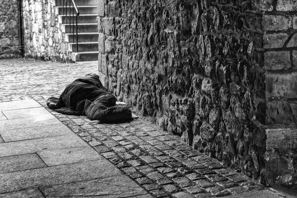 Sleeping men homeless in the city. black and white photography