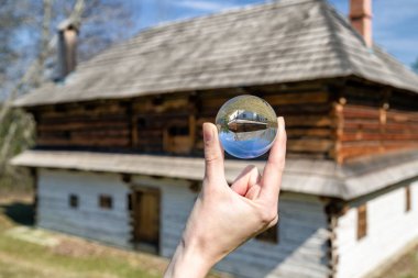 Crystal lensball and rural cottages in musem of the Slovak villa clipart