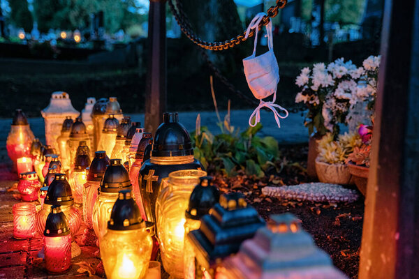 Memory of coronavirus Covid-19 victims during All Souls day. Lanterns on cemetery