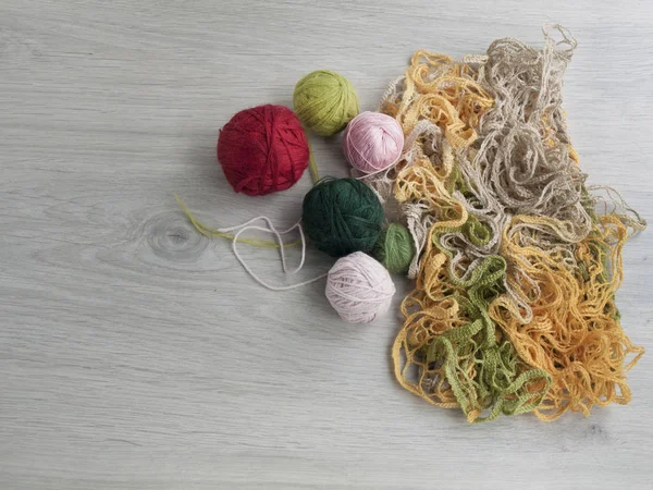 All for needlework: knitting, tangles of thread on a wooden gray table. Top view. Copy space — Stock Photo, Image