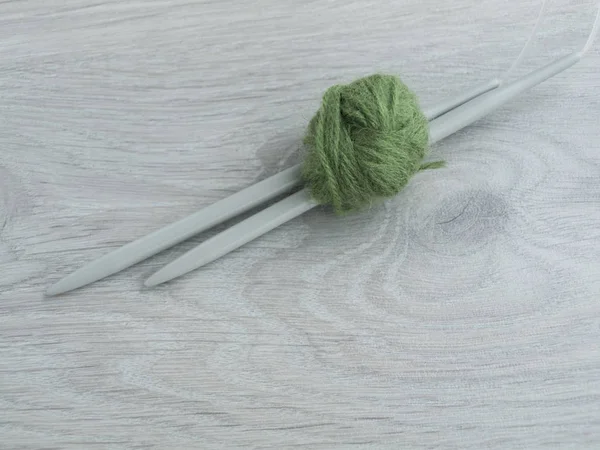 All for needlework: tangle of thread, knitting needles on a wooden gray table. ?op view. Copy space — Stock Photo, Image