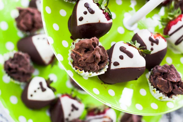 close up fancy chocolate handmade for a party on bright green plate