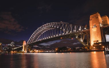 Sydney Harbour Bridge at night, view from Kirribilli, a steel through arch bridge across Sydney Harbour that carries rail, vehicular, bicycle, and pedestrian traffic. Australia : 04/02/18 clipart