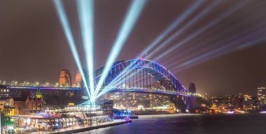 Avustralya-Sydney: Haziran 07,2017. Sydney Harbour Bridge görünümünden Circular quay çok pembe kırmızı ışıklar, karanlık gökyüzü üzerinde yıllık canlı ışık Sydney Festivali 2017 sırasında yansıtan ışık ile aydınlatılmış.
