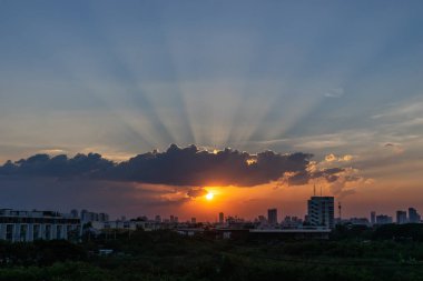 Sunbeam dramatik bulut ile arka planda Bina siluet günbatımı zamanı sırasında aracılığıyla