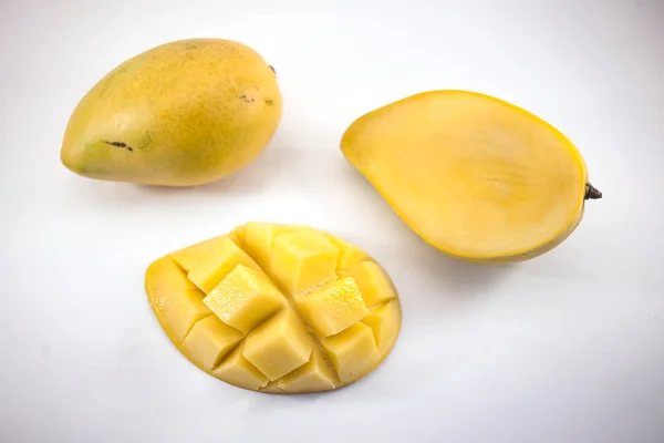 Yellow mango and mango slice with cubes isolated white background