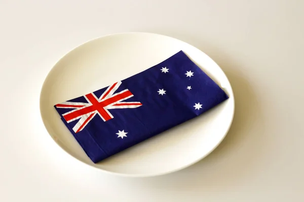 White dinner plate with an Australian flag napkin on it