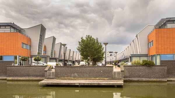 Modern street row houses and waterfront terrace in urban area of The Hague, Netherlands