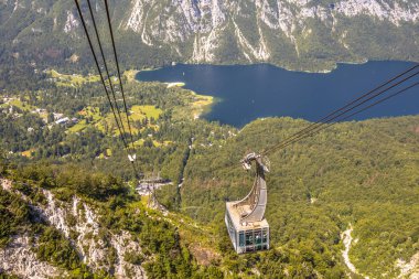Gondola ski lift in summer taking hikers into the mountains overlooking lake Bohinj near Bled, Slovenia