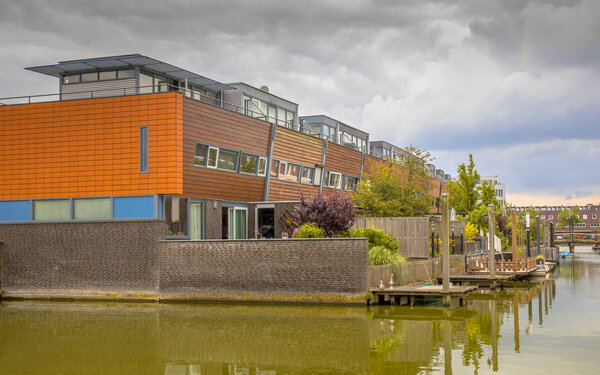 Modern row houses with  hanging terrace gardens on waterfront in urban area of The Hague, Netherlands