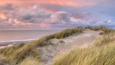 Sunset View from dune on North Sea and Canal in Zeeland, Netherlands clipart