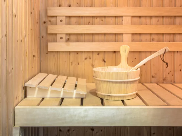 Interior of Finnish sauna with wooden bucket and seats
