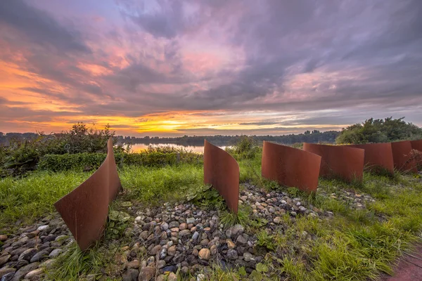 Metal wave objects in landscape — Stock Photo, Image