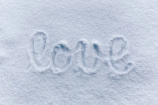 Love letters handwritten on sunny snow background.