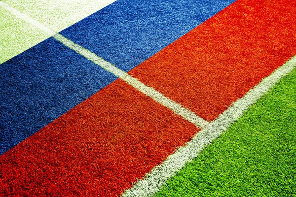 Empty soccer field detail with ground lines on sunny grass texture with painted Russia flag.