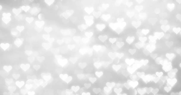 在模糊的银色博克反射背景上 闪亮的白色心脏运动 — 图库视频影像
