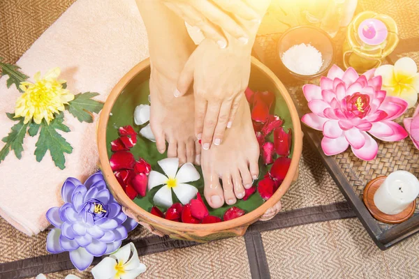 Perfect clean Asian female feet, Beautiful and elegant groomed girl\'s hand touches her feet, Spa, Scrub and foot care