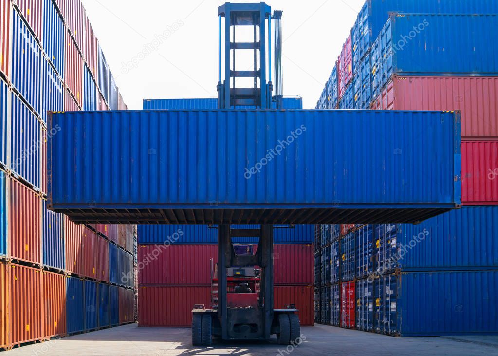 Forklift truck lifting cargo container in shipping yard or dock yard against sunrise sky for transportation import, Export and logistic industrial, Business logistic concept, Import and export concept