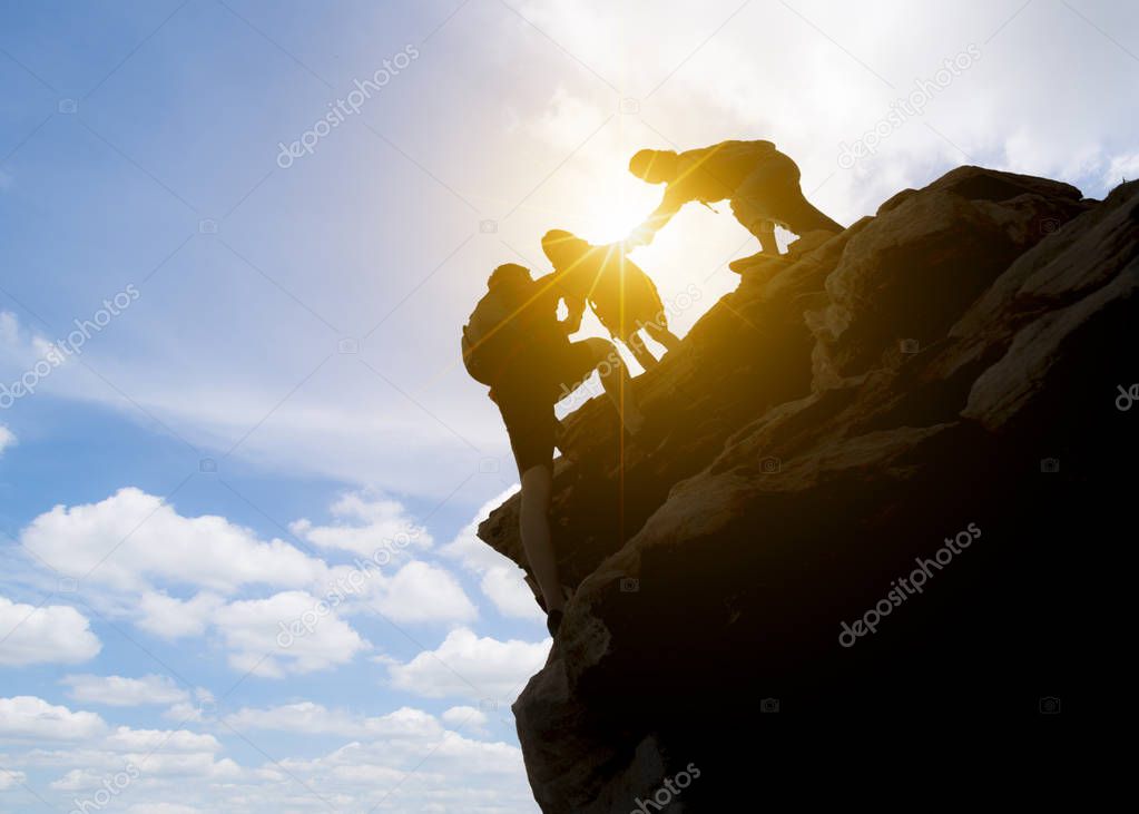 Asia couple hiking help each other silhouette in mountains with sunlight. couple hiking help each other silhouette in mountains with sunlight