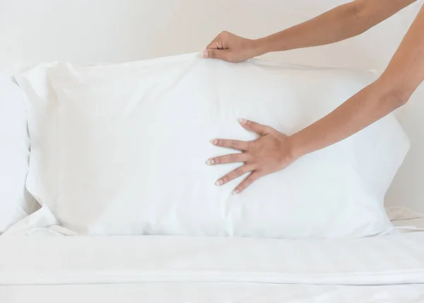 Close up hand set up white bed sheet in hotel room, Selective focus