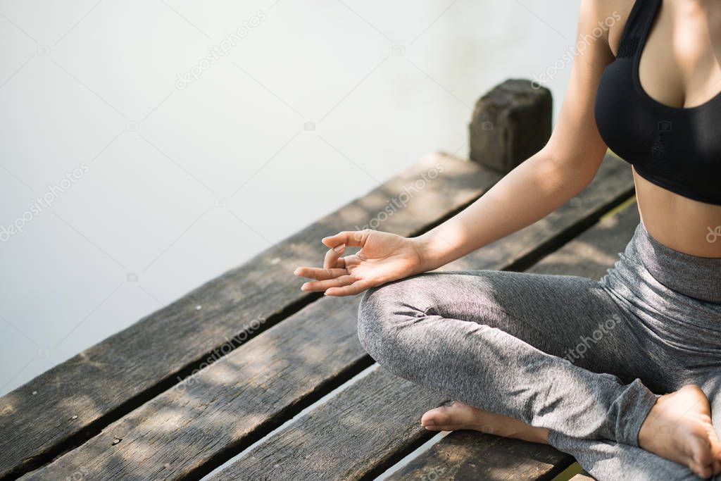 Young woman practicing yoga in the nature, Female happiness, Asian woman is practicing yoga at mountain lake