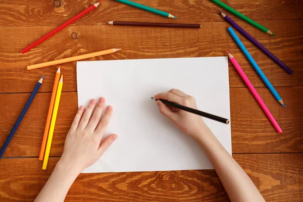 Child's hands with pencil view from above — Stock Photo, Image