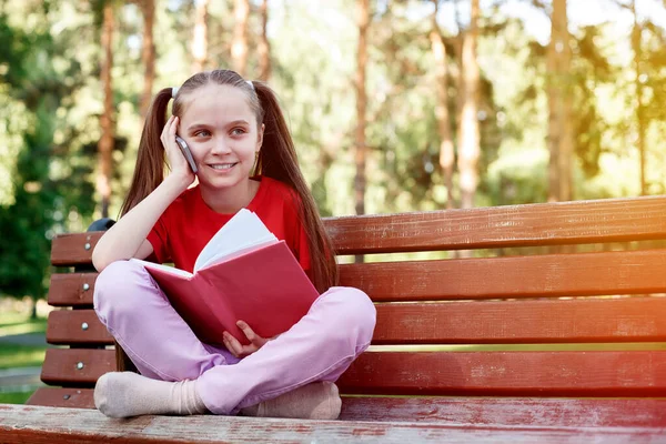 Niña Caucásica Con Una Cara Alegre Sosteniendo Teléfono Móvil Haciendo — Foto de Stock