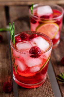 Biberiye, ahududu ve ahşap zemin üzerinde buzlu soğuk taze yaz limonatası.